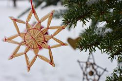 Norwegian Christmas traditions. Christmas ornaments hanging on a tree in the garden. snow.