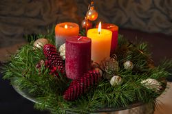 High Angle View Of Candles With Pine Cones And Wreath On Table