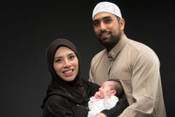 Happy muslim parents with newborn baby