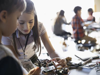 Boy and girl learning robotics in classroom