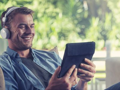 Young man listening to music with a digital tablet