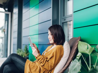 Young lady reading news on tablet