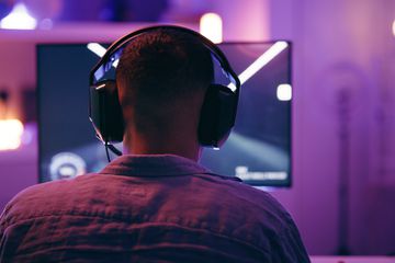 A person gaming with headphones