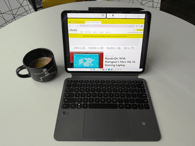 OnePlus Pad 2 on a table next to a coffee mug, showing Lifewire homepage