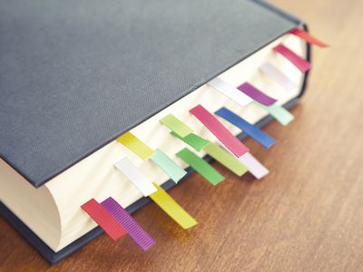 Book with a lot of different colored bookmarks