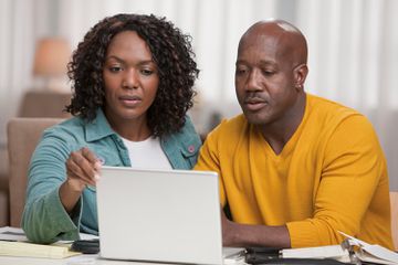 African American couple using laptop together