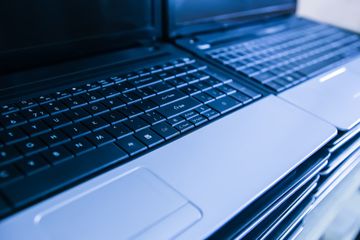 Refurbished laptops stacks and ready for sale.