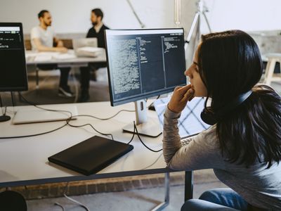 A person learning to code using a laptop and AI