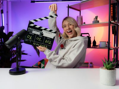 A person laughing with a clapperboard