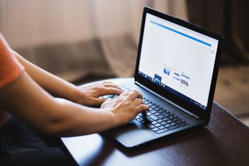 Person typing on laptop keyboard