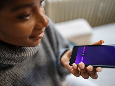 A woman speaking into the microphone of a smartphone