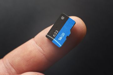 A 16GB MicroSD card on a person's index finger.