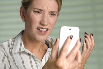 Image of woman frustrated with her phone.