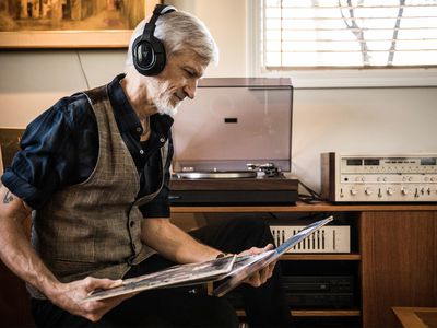 Man Listening to Vintage Stereo Setup