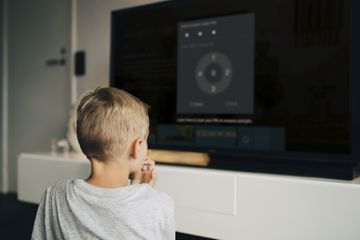 A boy waits as his parent uses Firestick parental controls to activate FreeTime.