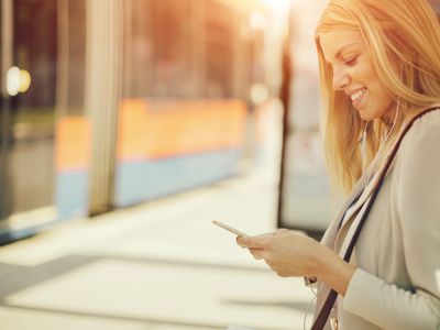 Traveler using Smart Phone at Bus Station