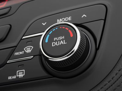 Temperature control dial and defroster buttons inside a car