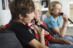 Three kids singing karaoke