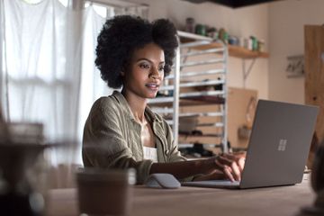 Woman using Windows 10 in S mode on a Microsoft Surface Laptop