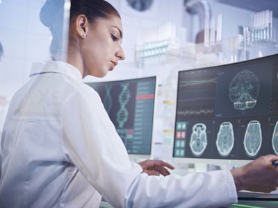 Neuroscientists examining brain scans in a lab.