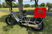 Cargo e-bike with milk crate attached to rear board.