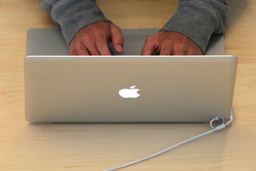 Person using a MacBook notebook.