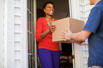 Picture of a woman receiving a package at her door