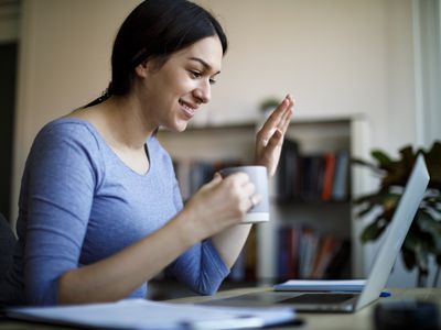 Woman having video call on laptop computer at home