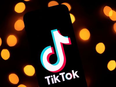 The TikTok logo on a phone with a lighted background