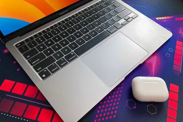 A MacBook Air with AirPods Pro in the foreground.