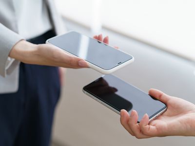 Women's hands showing each other the screen of the smartphone