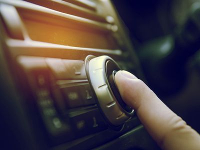 Person fiddling with a car radio