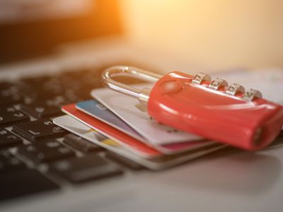 padlock and credit cards sitting on a keyboard, depicting computer security