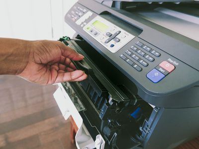 Changing the toner cartridge in a laser printer.