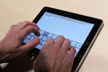 Hands typing on iPad