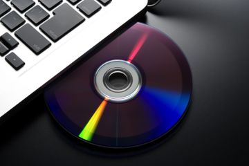 DVD inserting into a laptop optical disk drive