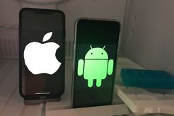 iPhone (left) and Android phone (right) inside a freezer with ice to the right of the phones