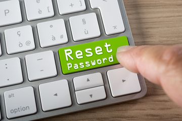 A big, green Reset Password button on a computer keyboard.