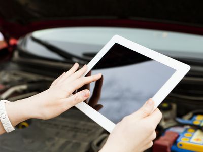 Person using an iPad with a black screen