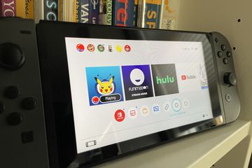 Nintendo Switch in portable mode displaying streaming apps on Home screen.