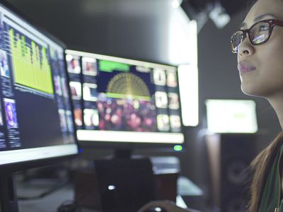 Data analyst looking at computer screens with information on them