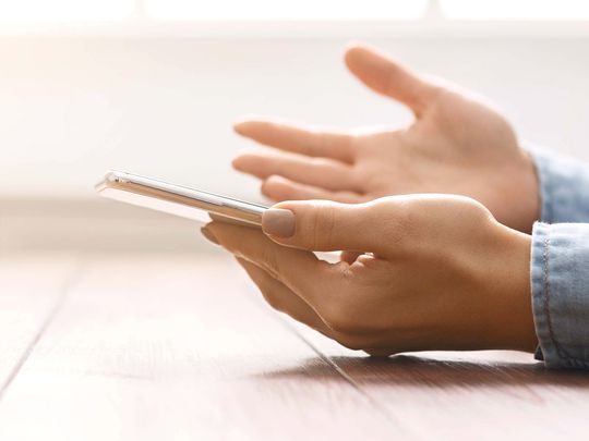 A woman's hands holding an iPhone smartphone.