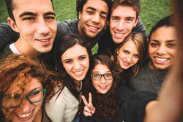 Friends posing for group selfie