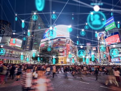 Photo of Hachiko Crossing in Shibuya, Tokyo, Japan with digital network blue light rendered on top.