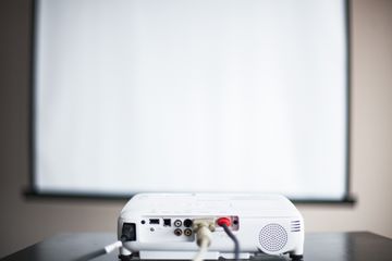 Projector and screen in a bare room