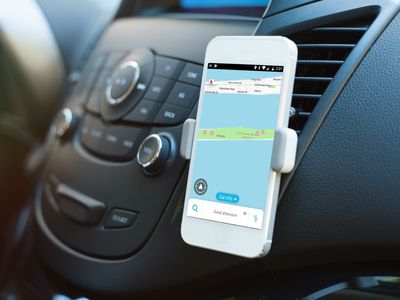 A car app displayed on a phone in a car dash mount.