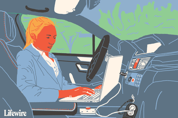 Illustration of a person using a laptop in their car via a power inverter