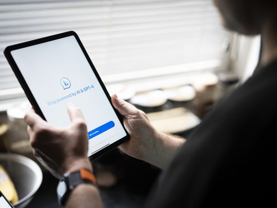 Someone using Microsoft Bing Chat and AI assistant on a tablet. 