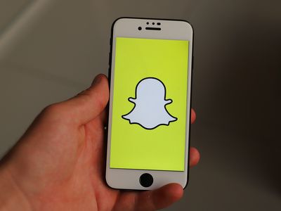 An image of the Snapchat ghost icon on a smartphone screen