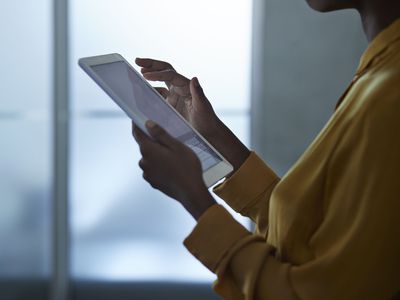 Save to Board Close-up of businesswoman using tablet, at office